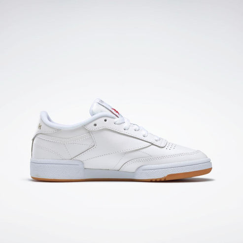 A low-top tennis shoe with white leather upper and light brown rubber sole.