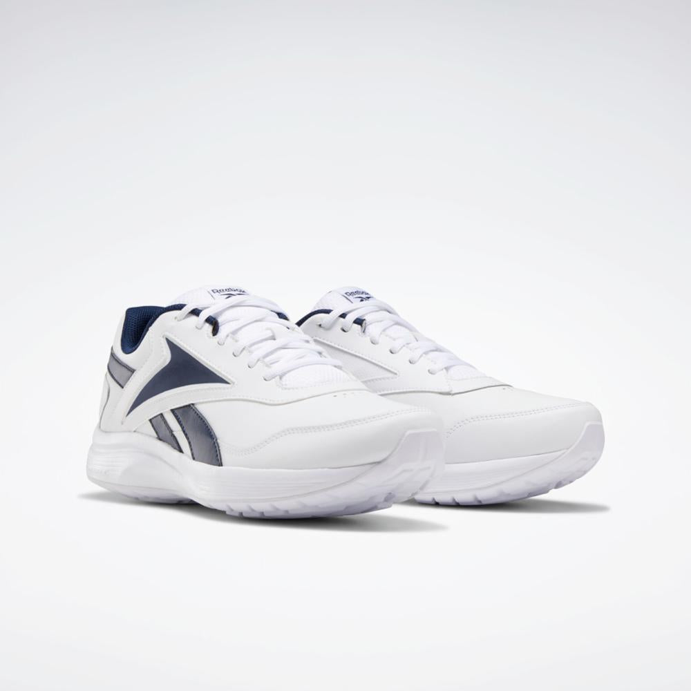 A pair of white athletic shoes with navy blue accents.
