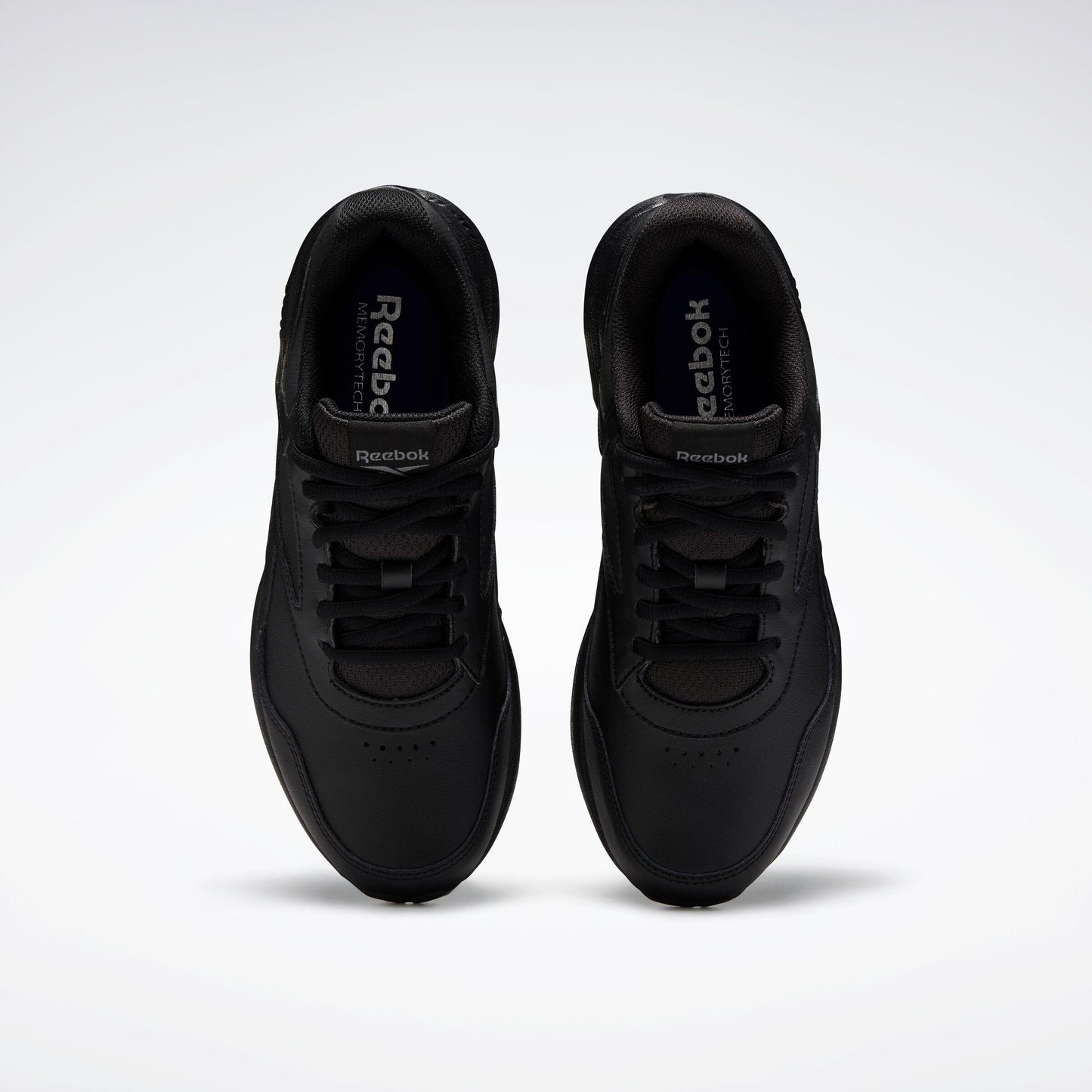 A pair of all-black sneakers with black laces and a rounded toe.