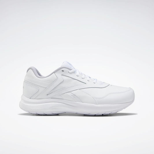 White shoe with a low profile, rounded toe, lace-up closure, and textured sole.