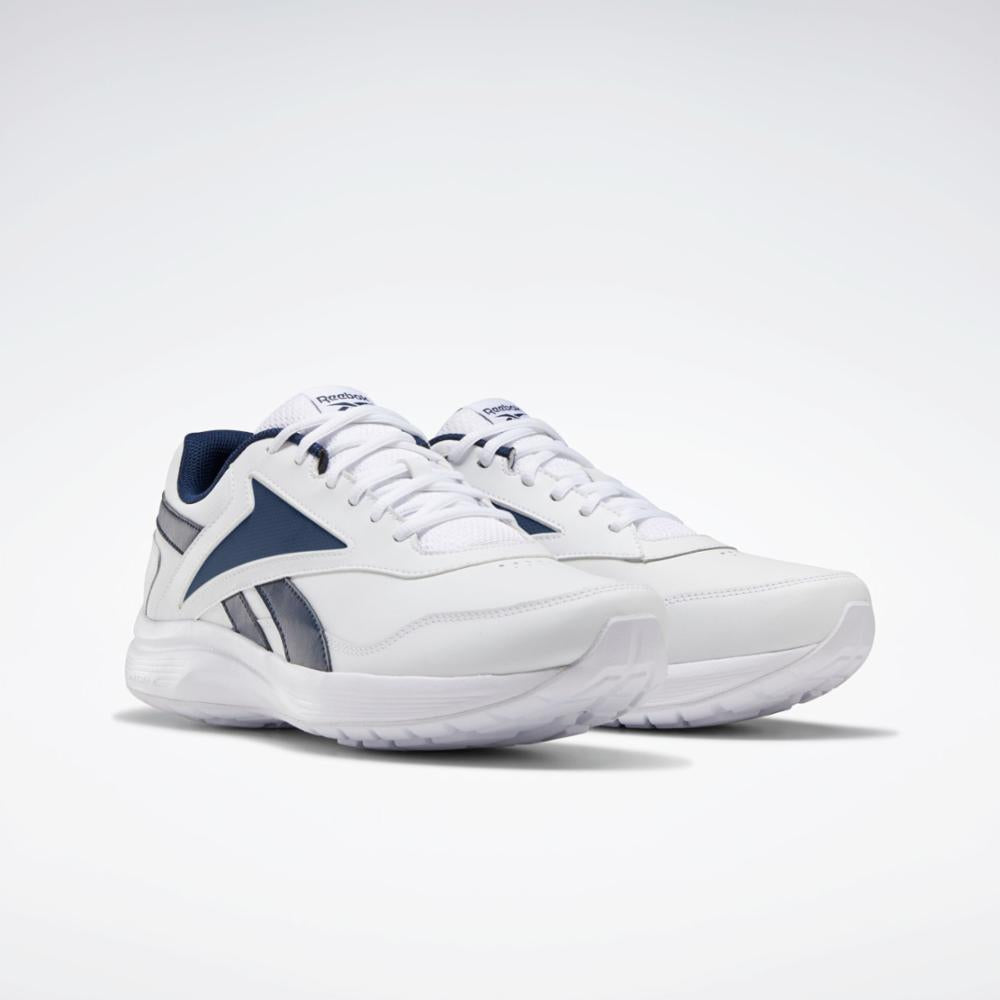 Pair of white athletic shoes with navy blue accents.