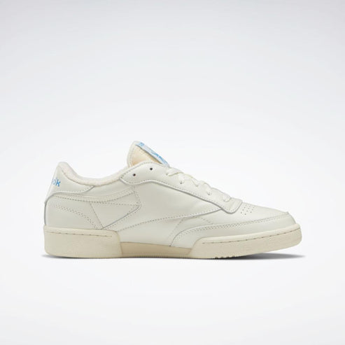 Off-white low-top sneaker with stitched side detail.