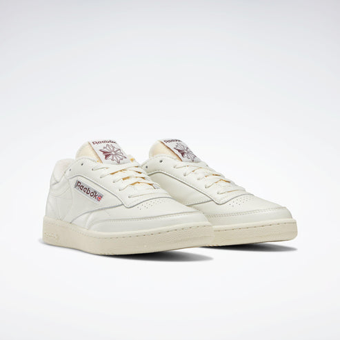 Low-cut off-white sneakers with logo on tongue and side.
