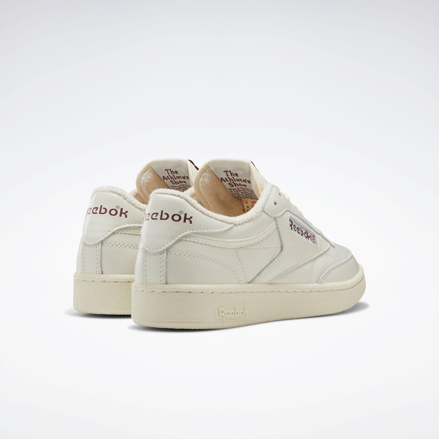 Off-white leather sneakers with logos.