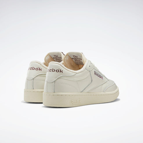 Off-white leather sneakers with logos.