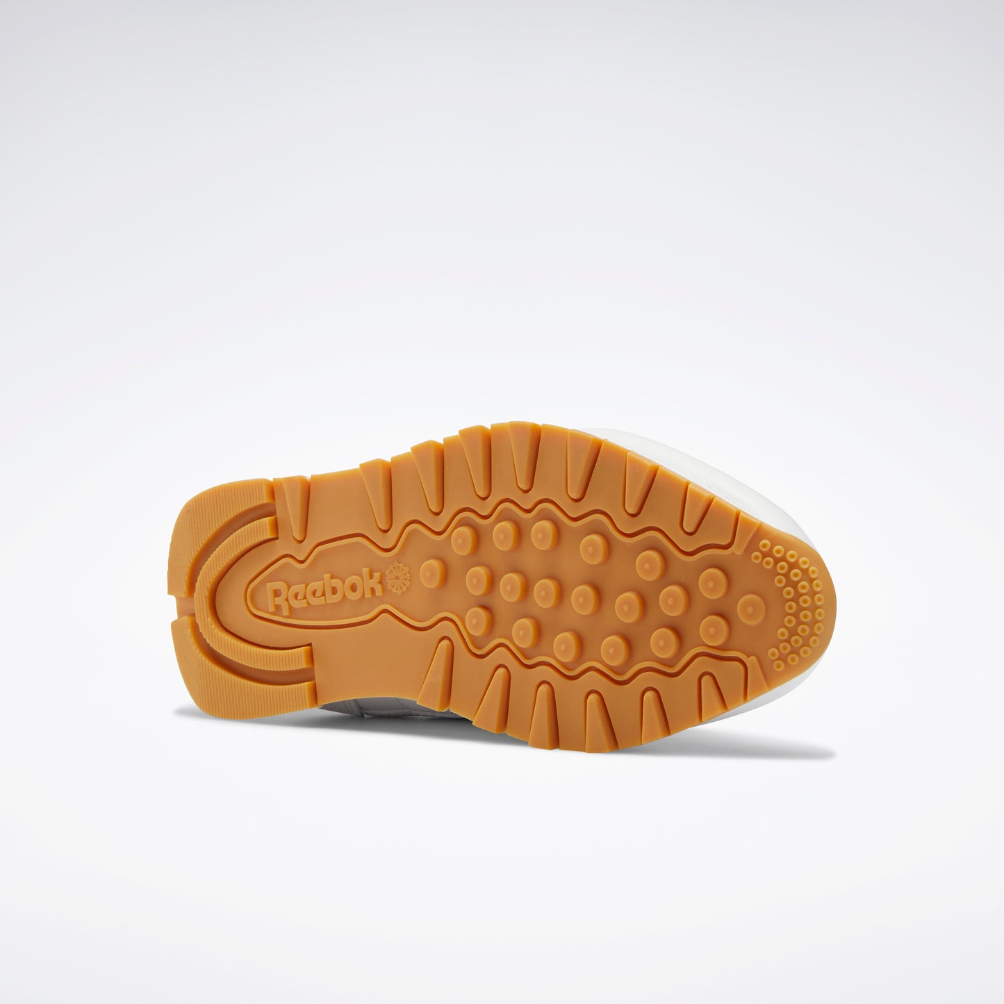 Brown outsole with a round heel and logo.