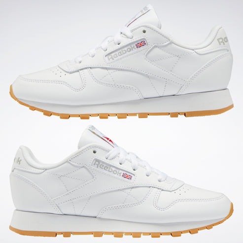 Two white leather sneakers with a gum sole.