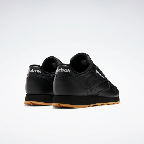 Rear view of black low-top sneakers with gum soles. The word "ebok" is on the heel.