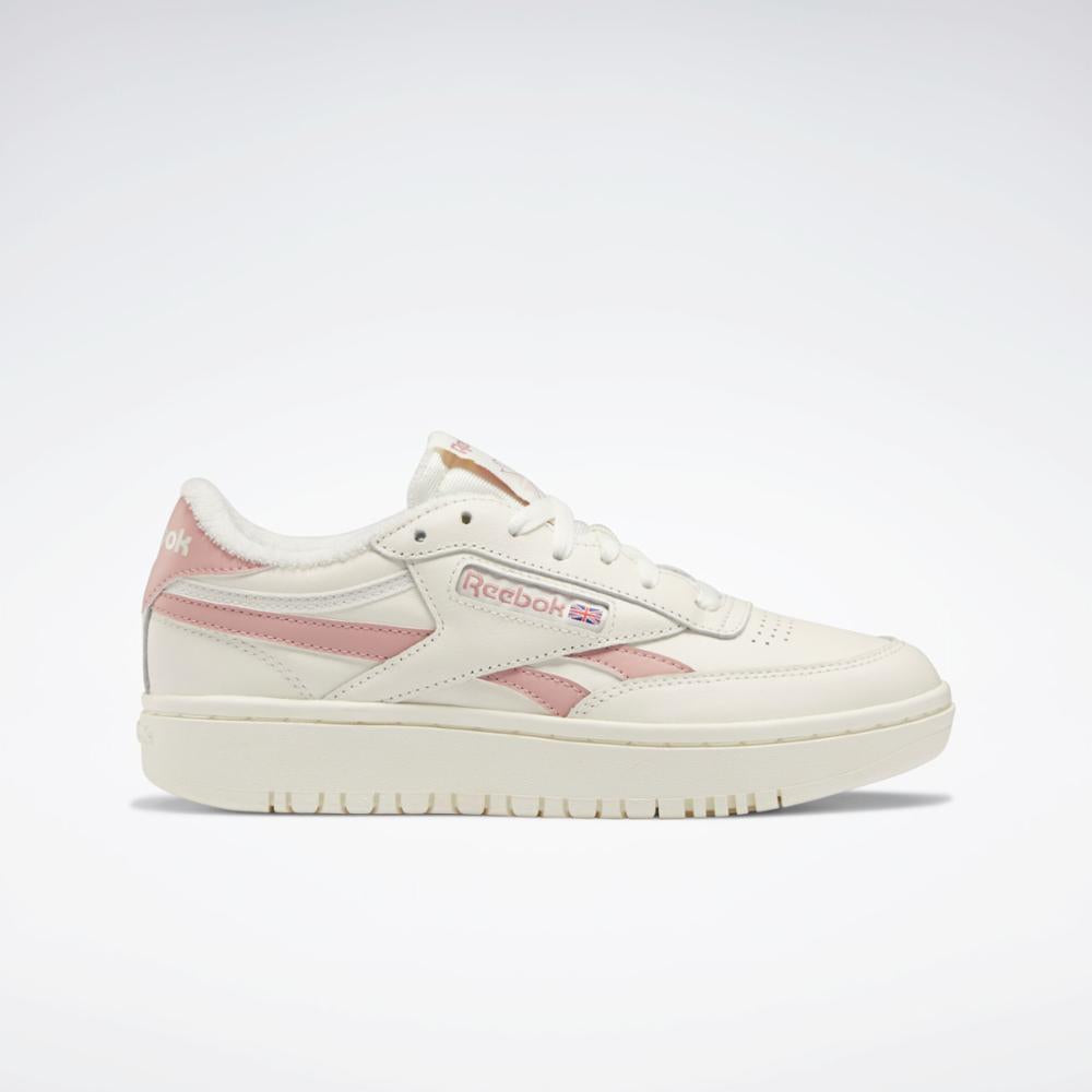 Off-white sneaker with pink side stripes and logo.