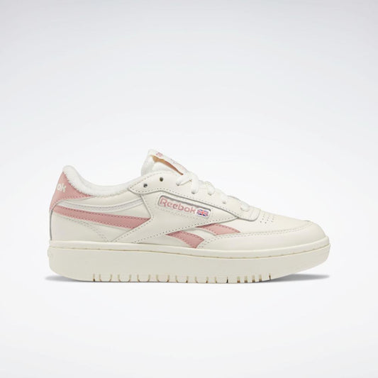 Off-white sneaker with pink side stripes and logo.