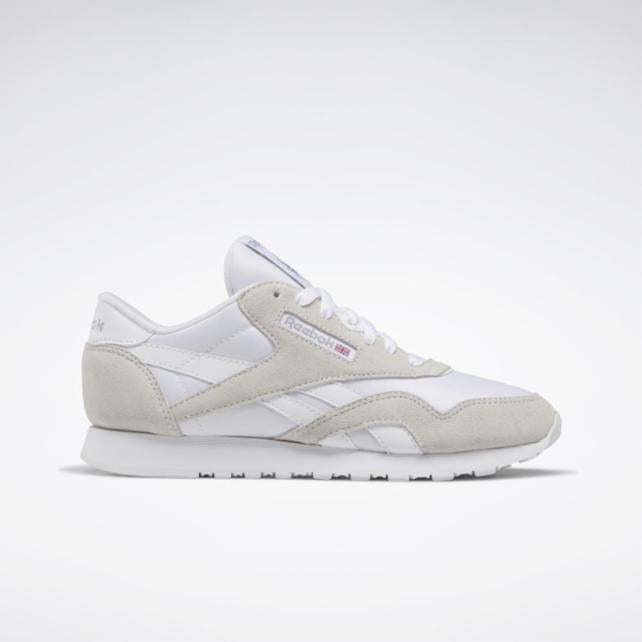 White sneaker with suede overlays and rubber sole.