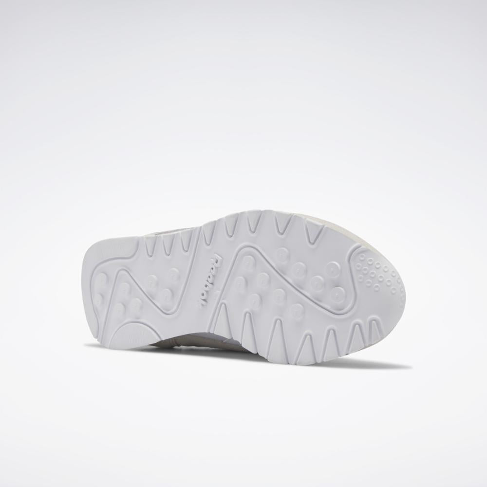 Bottom of a white shoe with a textured sole.