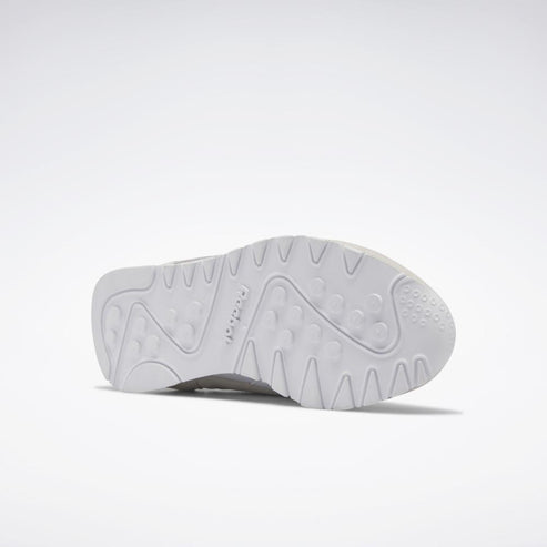 Bottom of a white shoe with a textured sole.