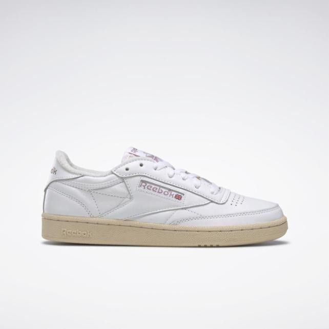White low-top sneaker with beige sole and Reebok branding.
