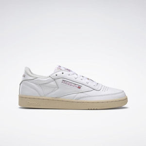 White low-top sneaker with beige sole and Reebok branding.