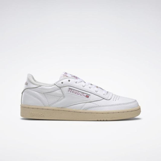 White low-top sneaker with beige sole and Reebok branding.