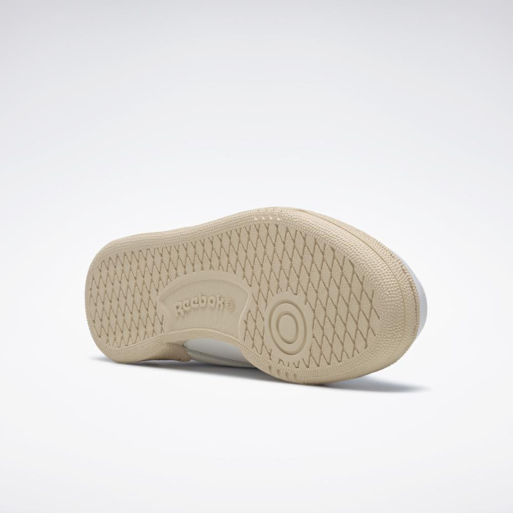 Bottom of the sneaker, showing the diamond pattern beige-colored sole with a Reebok logo.