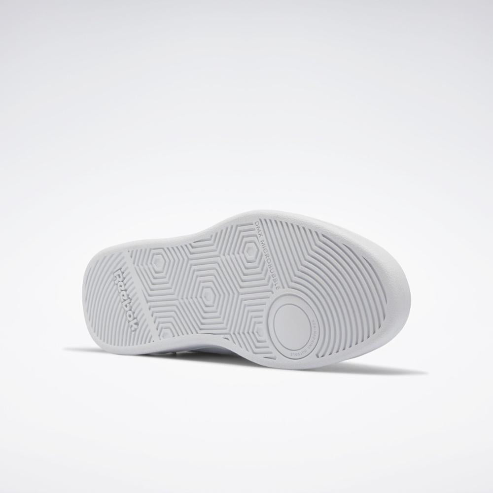 White shoe sole with hexagon and radial patterns and 'Reebok' printed on the side.