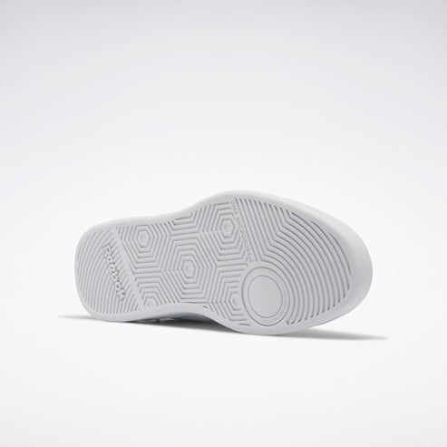 White shoe sole with hexagon and radial patterns and 'Reebok' printed on the side.
