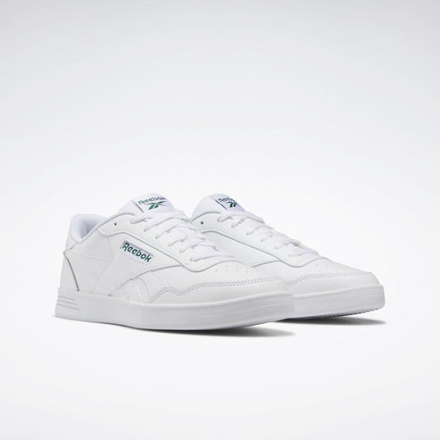 Two white sneakers with green lettering.