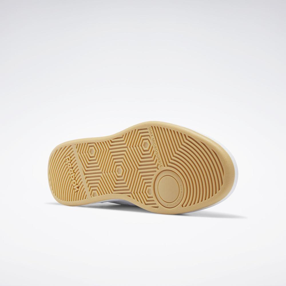 The bottom of a light tan shoe shows concentric circles at the heel, hexagonal pattern on the forefoot, and the word "REEBOK".