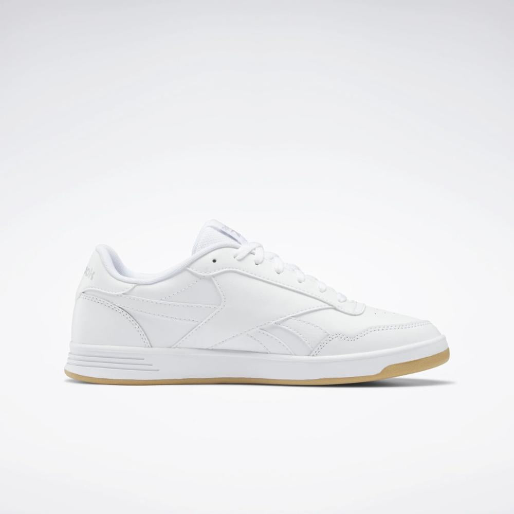 A low top, white sneaker with a brown gum sole.
