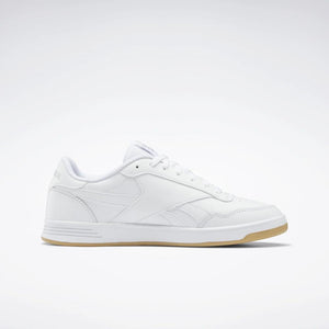 A low top, white sneaker with a brown gum sole.