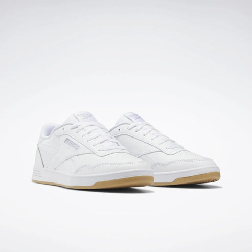 A pair of white court sneakers with gum soles.