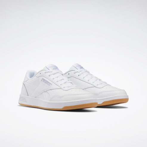 Low-top white sneaker with a gum sole and printed text on the upper.