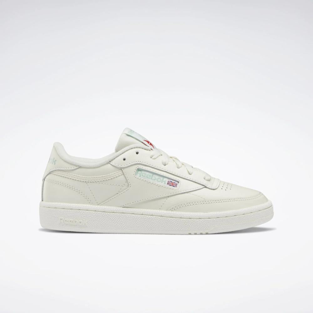 Off-white low-top sneaker with white sole and laces.