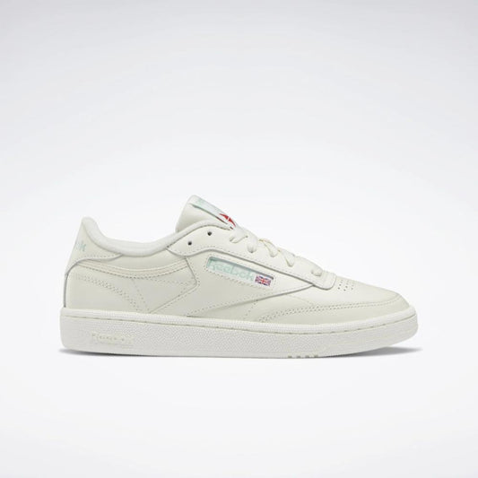 Off-white low-top sneaker with white sole and laces.