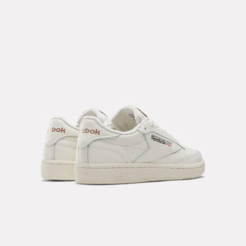 Side view of off-white sneakers with logo on side heel.