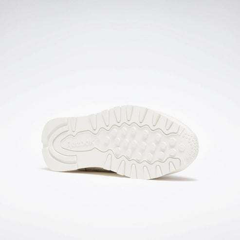 Off-white outsole of a shoe with a repeating geometric pattern.