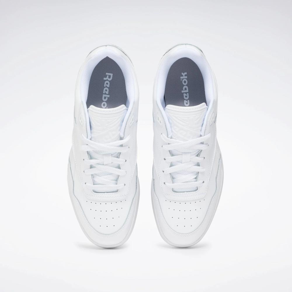Pair of all-white sneakers, view from above.
