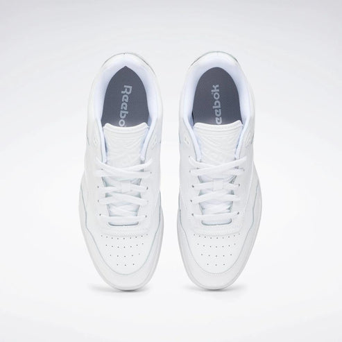 Pair of all-white sneakers, view from above.