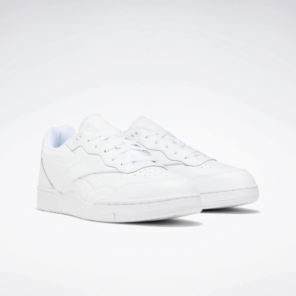 Low-top white sneakers with white laces.