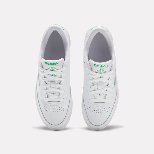 White sneakers, top view, green logo, white laces.