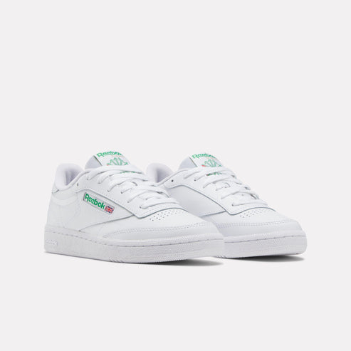 Pair of white leather sneakers with green logos.