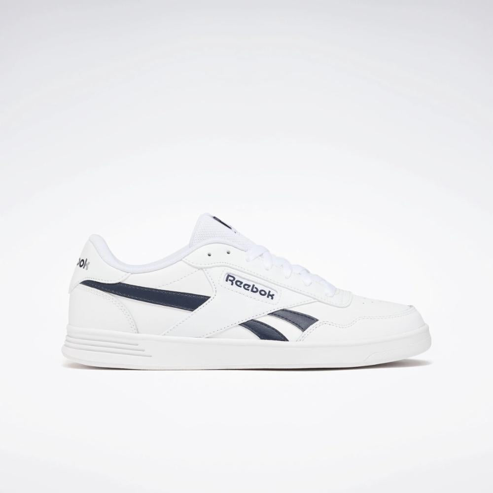 White sneaker with navy accents and "Reebok" in navy text.