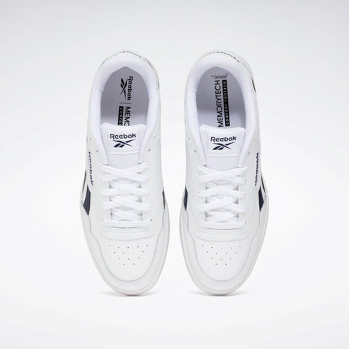 Top-down view of white athletic shoes with a perforated toe box and white laces. Black logo on the side and insole visible.
