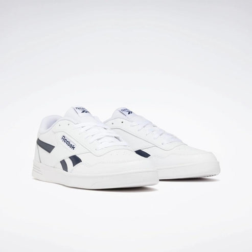 White sneakers with dark blue logo on the side and tongue.
