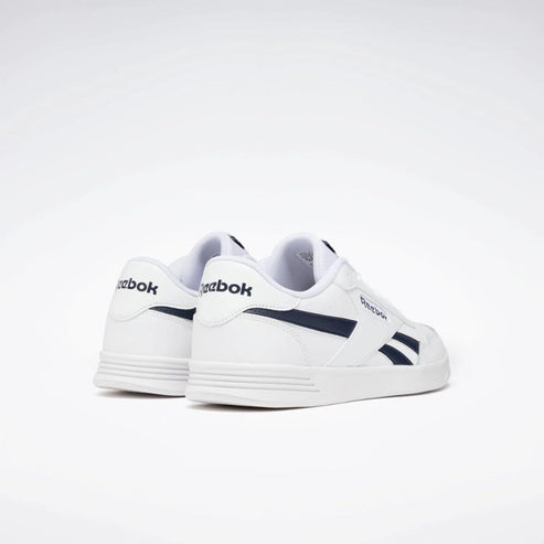 White sneakers with navy accents, featuring the word "Reebok" on the heel.