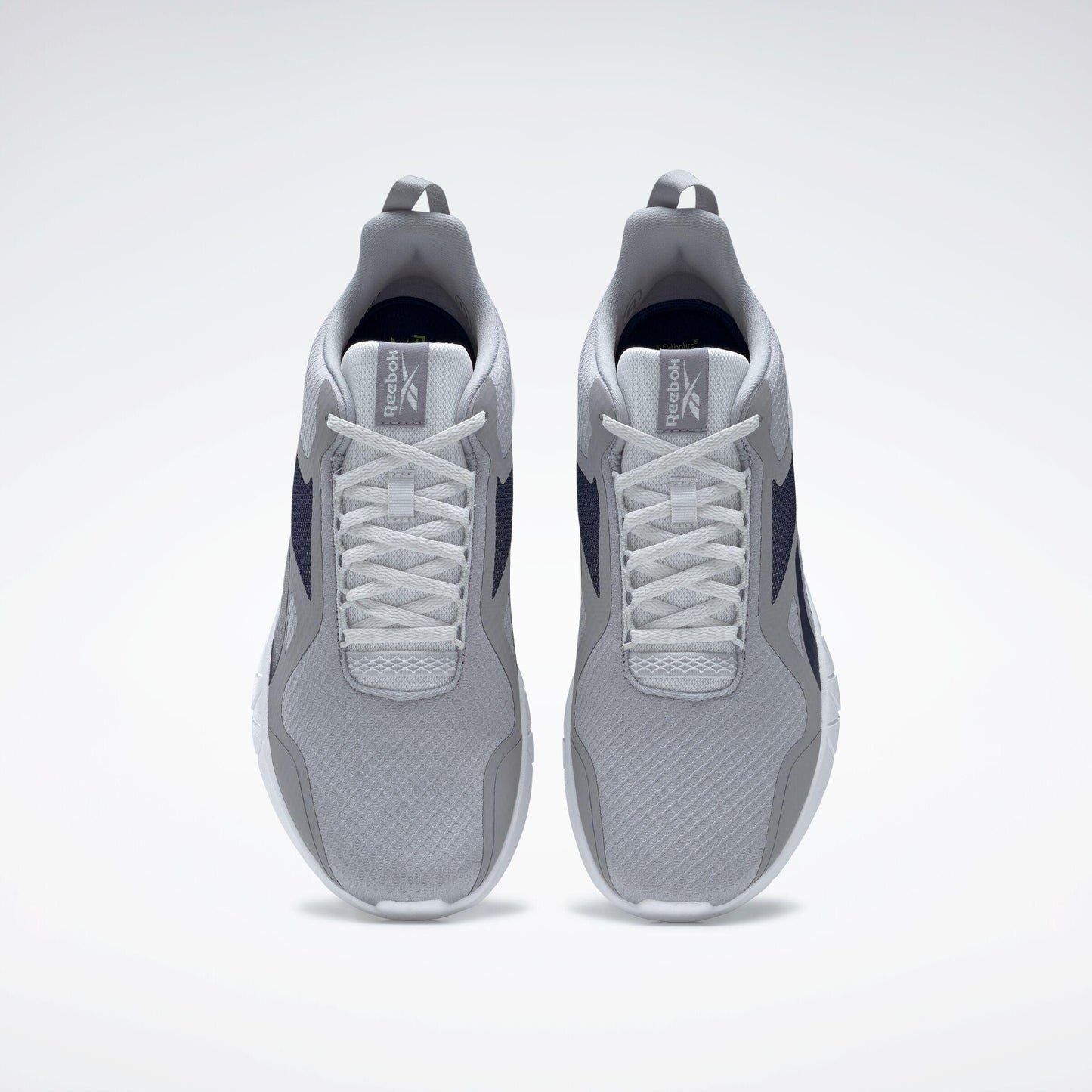 A pair of running shoes in gray with white laces, viewed from above.