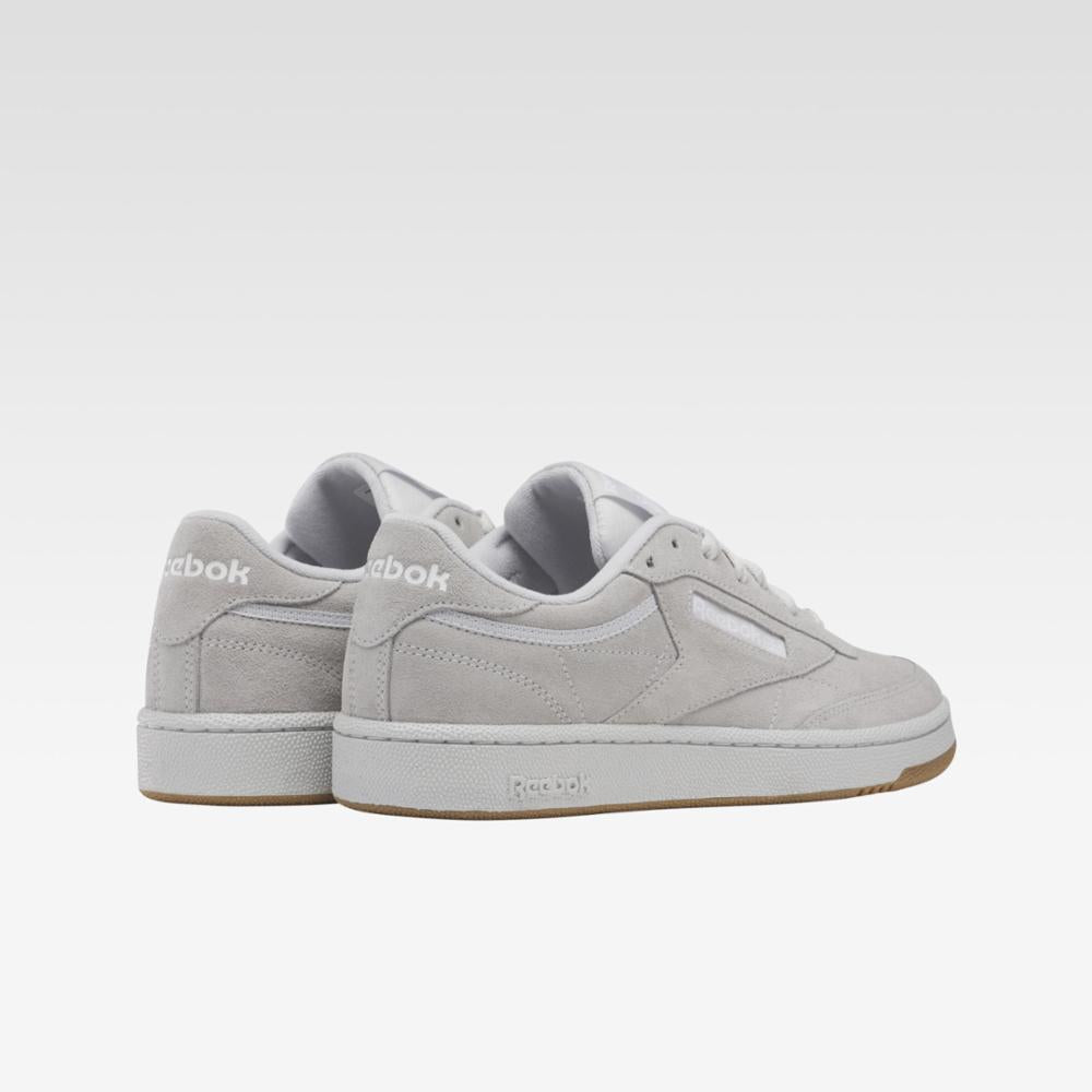 low top sneakers in gray suede with white text on the heel