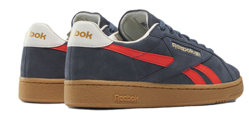 Low-top navy sneakers with red stripes, gum sole, and white heel.