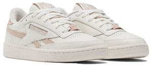 A pair of low-top sneakers, primarily off-white with light pink accents.