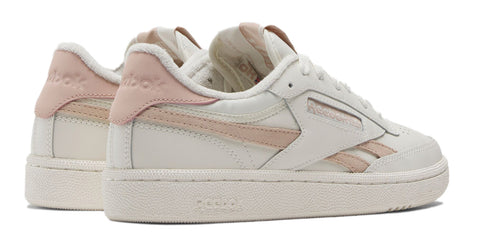 A pair of off-white shoes with pink accents.