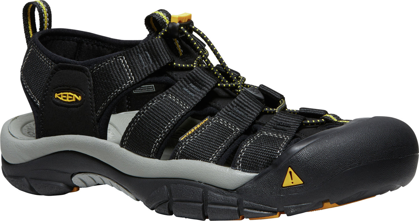 A black hiking sandal with gray sole and yellow accents.