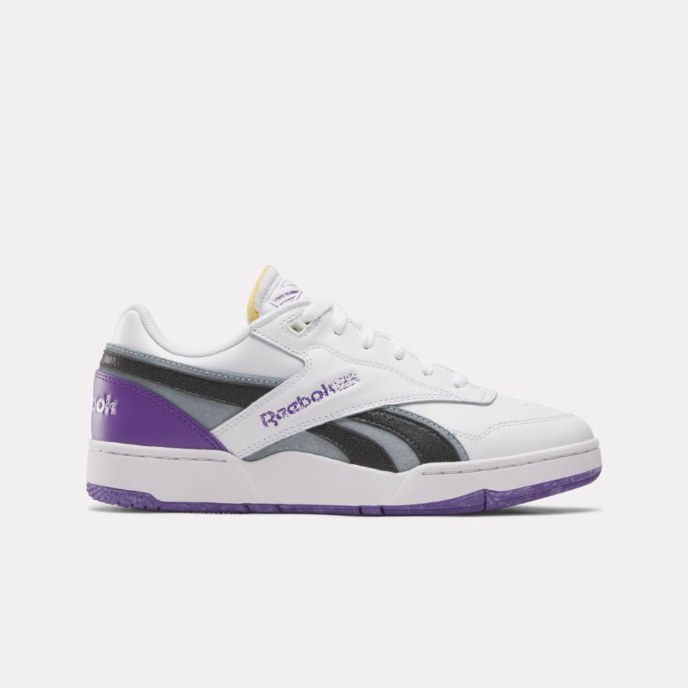 White sneaker with purple, gray and black accents, 'Reebok' text on side.