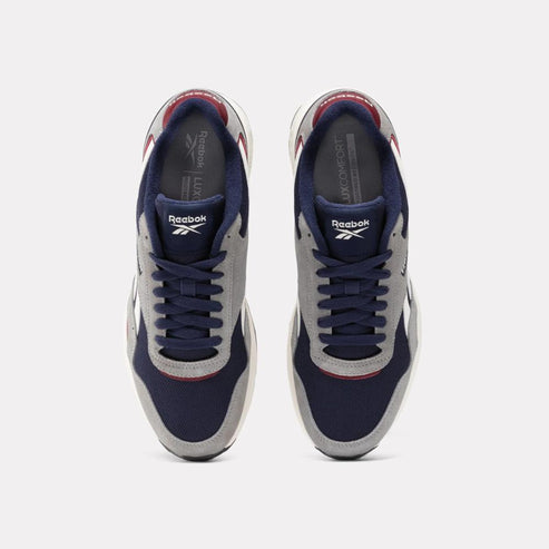Pair of running shoes, top view. Shoes have dark blue toe, gray vamp, dark blue laces, and dark red inside.